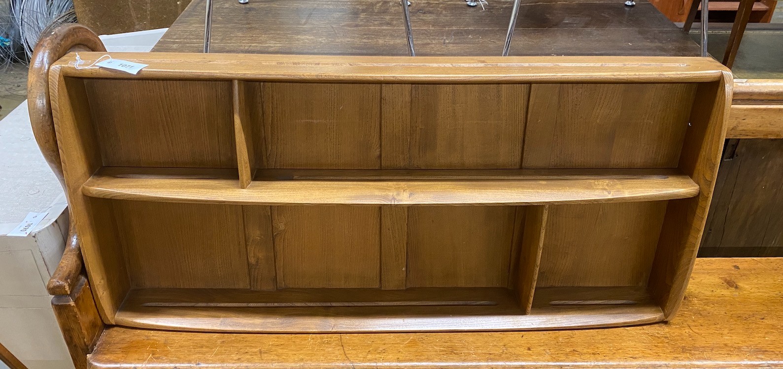 An Ercol elm plate rack, width 107cm, depth 13cm, height 49cm